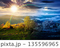 mountain landscape in fog. day and night time change concept. lush green alpine meadows in spring with sun and moon at twilight. beautiful view in to the valley. seasonal equality and shift template 135596965