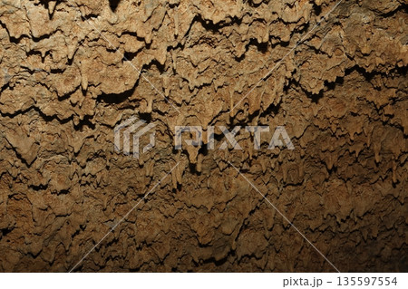 Lava stalactites in the ceiling of a cave. 135597554