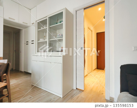 Living room design with white buffet and pencil case door. Scandinavian-style interior. Minimalism and modern renovation. Living room design with white buffet and pencil case door. Scandinavian-style interior. Minimalism and modern renovation. 135598153