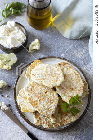 Rustic cauliflower pancakes with fresh herbs and ricotta for a gourmet brunch Rustic cauliflower pancakes with fresh herbs and ricotta for a gourmet brunch 135598546