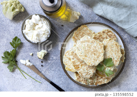Healthy cauliflower fritters with ricotta and fresh parsley on rustic background 135598552