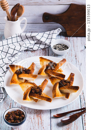 Baked creative toasts with berry jam on a plate on the table vertical view Baked creative toasts with berry jam on a plate on the table vertical view 135599013