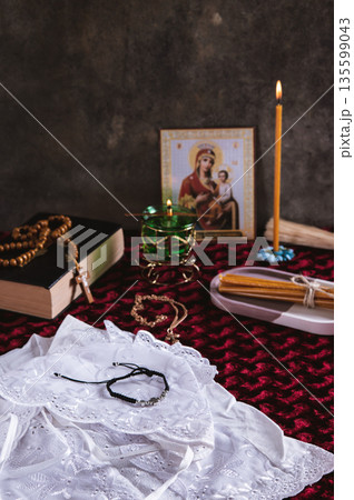 An Orthodox cross, candles, a lamp, and an icon for home prayer on the table vertical view An Orthodox cross, candles, a lamp, and an icon for home prayer on the table vertical view 135599043