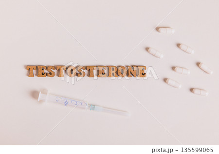 Close up of syringe and capsules for regulating testosterone levels top view 135599065