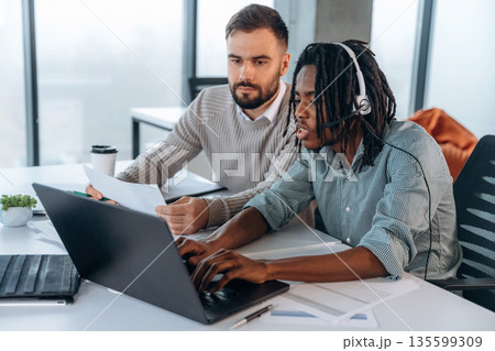 Modern office. Two men are working Modern office. Two men are working 135599309