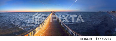 Symmetry on Groemitz pier at dusk 135599431