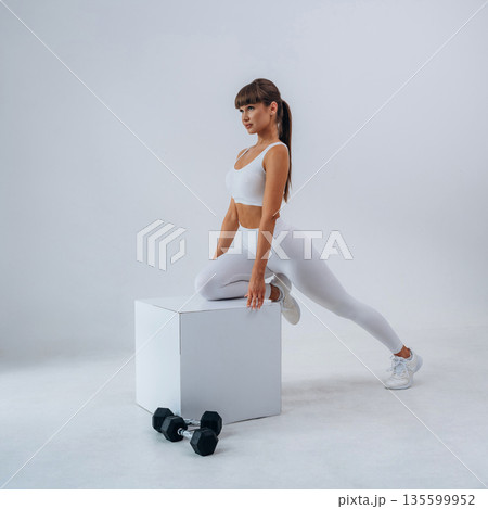 Young sportive woman is in the studio Young sportive woman is in the studio 135599952