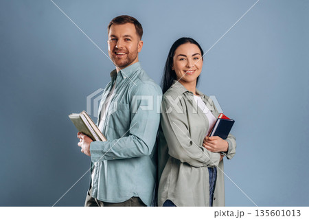 Education concept, ready for university. Man and woman are in the studio Education concept, ready for university. Man and woman are in the studio 135601013