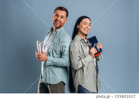 Teachers are with books and notepads. Man and woman are in the studio 135601017