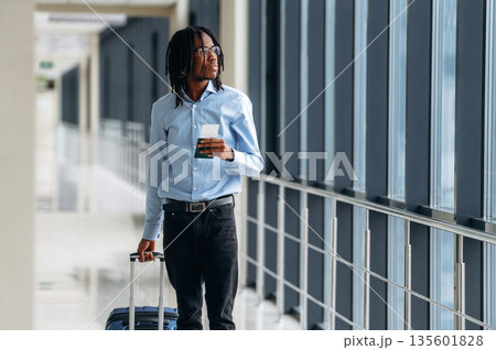 Male tourist is in the airport corridor Male tourist is in the airport corridor 135601828