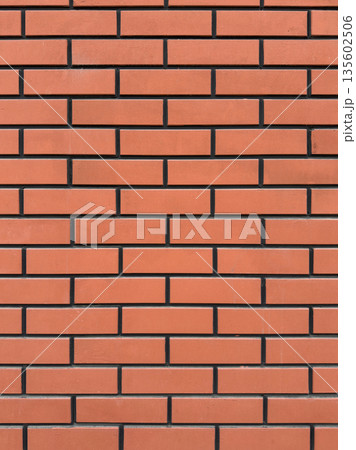 Orange brick wall texture with uniform color and dark mortar lines 135602506