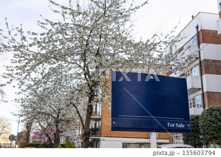 Real Estate For Sale Sign in Front of Residential Building Real Estate For Sale Sign in Front of Residential Building 135603794