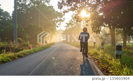 man riding bicycle on road 135603904