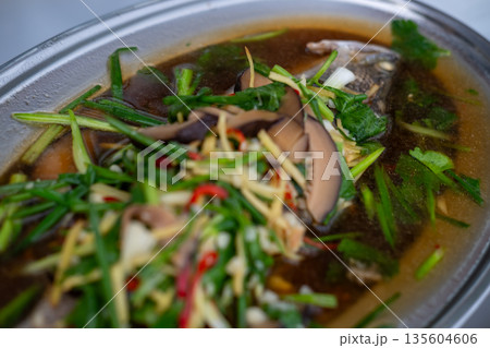 Streamed Seabass Fish with Soy Sauce served on plate. Thai food Streamed Seabass Fish with Soy Sauce served on plate. Thai food 135604606