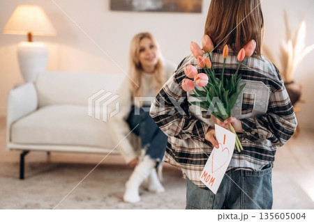 I love mom text on gift card, with flowers. Mother and daughter are together in domestic room 135605004