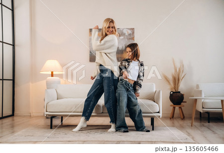 Party, dancing and having fun. Mother and daughter are together in domestic room Party, dancing and having fun. Mother and daughter are together in domestic room 135605466