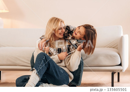 Mother and daughter are together in domestic room Mother and daughter are together in domestic room 135605501
