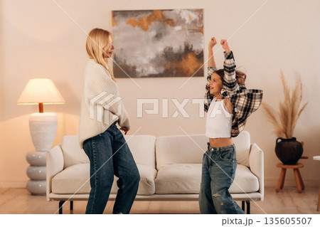 Mother and daughter are together in domestic room Mother and daughter are together in domestic room 135605507
