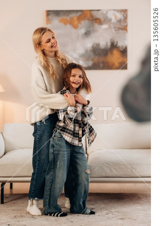 Mother and daughter are together in domestic room 135605526