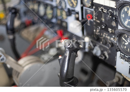 Aircraft cockpit showing flight control stick and instrument panel 135605570