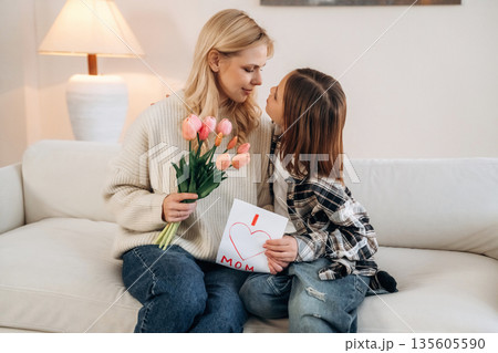 Presents for woman at mother's day. Family are together in domestic room 135605590