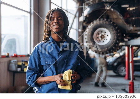 Cleaning the hands after work. Male mechanic is with car in garage 135605930