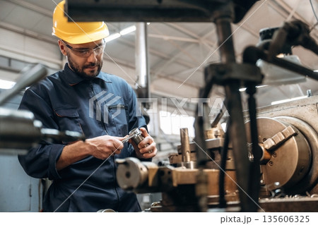 Metal job, by machine. Man is working in the factory Metal job, by machine. Man is working in the factory 135606325