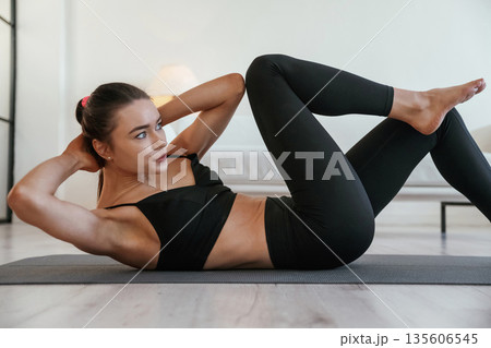Sport time, wellness. Young woman with slim body type is indoors Sport time, wellness. Young woman with slim body type is indoors 135606545