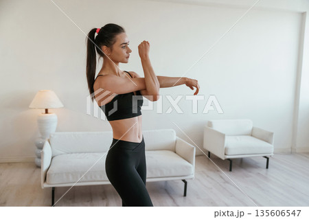 Hands warm up. Young woman with slim body type is indoors 135606547