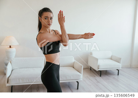 Hands warm up. Young woman with slim body type is indoors Hands warm up. Young woman with slim body type is indoors 135606549