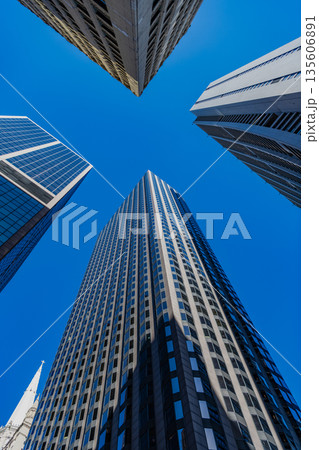 Office building in business district. Skyscraper building architecture. Business skyscraper. Modern glass building. Skyscraper in city downtown. City downtown with skyscraper. Tall tower 135606891