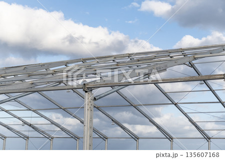 Installation of metal structure. Metal construction backdrop. Structural iron engineering. Structure engineering at building site. Framework construction architecture. Architectural detail Installation of metal structure. Metal construction backdrop. Structural iron engineering. Structure engineering at building site. Framework construction architecture. Architectural detail 135607168