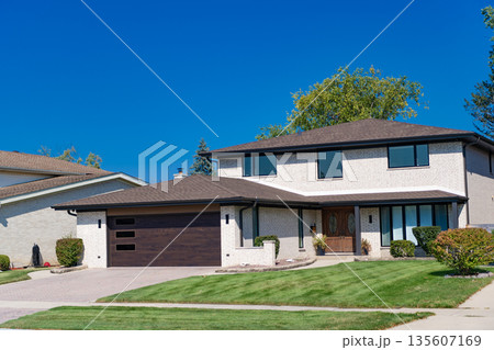 Suburban house architecture. Private house. Neighborhood architecture. Property in neighborhood. Residential property house. Residence architecture. Suburban neighborhood. Housing shortage 135607169