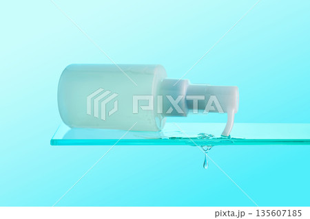 Cosmetic pump bottle spilling gel serum from glass shelf Cosmetic pump bottle spilling gel serum from glass shelf 135607185