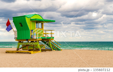 Lifeguard over Miami beach. Panoramic seascape of Miamis famous coastline. South Miami Beach. Miami Beach jetty. Rescue tower against the blue sky in Miami. Beautiful coastal view of Florida. 135607212