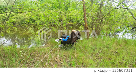 Woman relaxing in nature. people on vacation. People relaxing. Summer holiday Woman relaxing in nature. people on vacation. People relaxing. Summer holiday 135607311