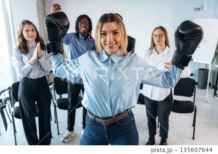 Sport of boxing. Group of young business people are in conference room 135607644