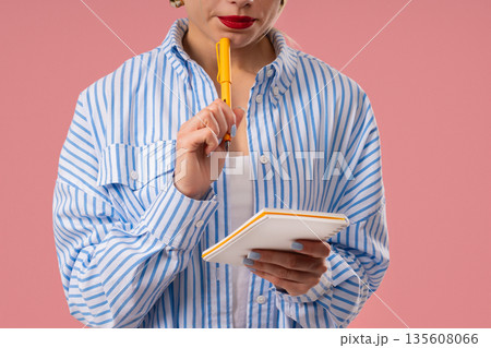 Young Woman Writing Notes In Planner With Pen. Pretty Girl Thinking About Future Young Woman Writing Notes In Planner With Pen. Pretty Girl Thinking About Future 135608066