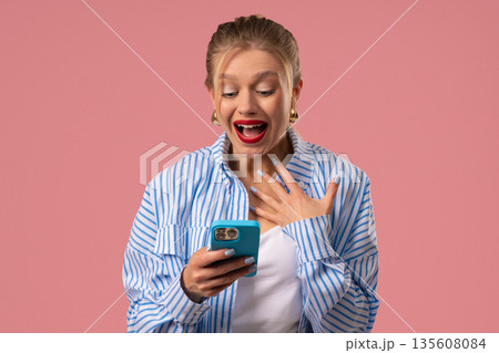 Surprised Shocked Woman With Smartphone. Happy Girl, Pink Studio Background, Joy Surprised Shocked Woman With Smartphone. Happy Girl, Pink Studio Background, Joy 135608084