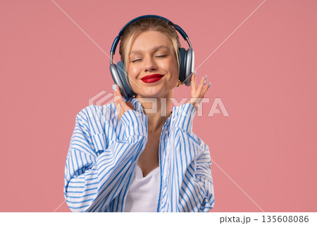 Happy Feminine Woman Listening Music, Enjoying Dance With Headphones On Pink Happy Feminine Woman Listening Music, Enjoying Dance With Headphones On Pink 135608086
