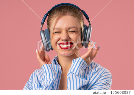 Happy Feminine Woman Listening Music, Enjoying Dance With Headphones On Pink Happy Feminine Woman Listening Music, Enjoying Dance With Headphones On Pink 135608087