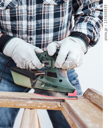 Carpenter at work, restoring an old wooden window. Carpentry. Carpenter at work, restoring an old wooden window. Carpentry. 135608935