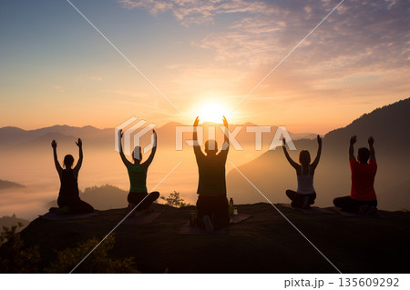 Group of people doing yoga in nature during sunset or sunrise Group of people doing yoga in nature during sunset or sunrise 135609292