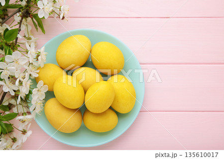 Easter eggs and spring flowers on pink background. Space for text Easter eggs and spring flowers on pink background. Space for text 135610017