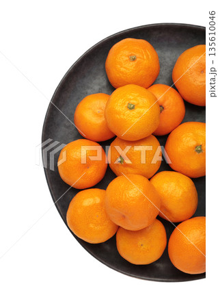 Fresh small tangerine mandarin orange in plate isolated on white background. Fresh small tangerine mandarin orange in plate isolated on white background. 135610046