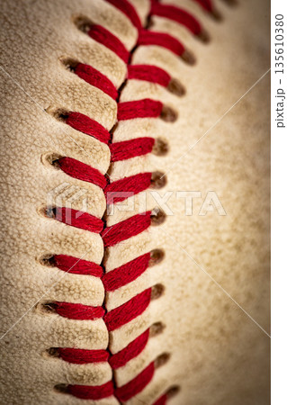 Macro close-up baseball ball with stiches and seam Macro close-up baseball ball with stiches and seam 135610380