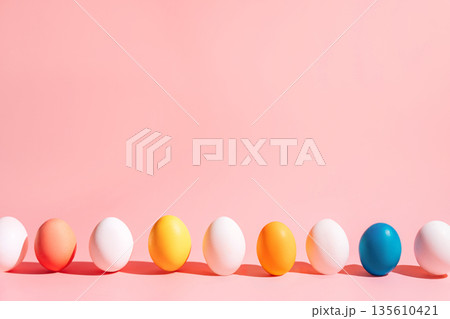 Easter eggs row on pink background with copy space, minimal composition 135610421