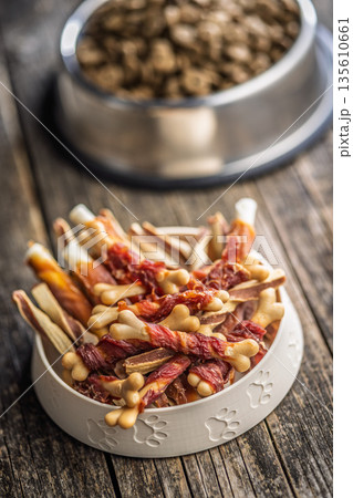 Dog food. Snack sticks for dogs in bowl on wooden table. Dog food. Snack sticks for dogs in bowl on wooden table. 135610661