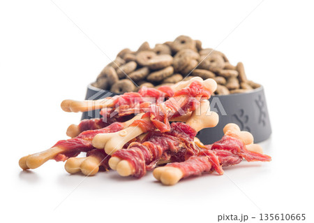Dog food. Snack sticks for dogs isolated on white background. 135610665