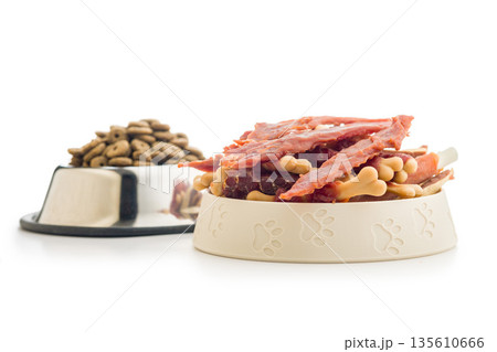Dog food. Snack dried meat for dogs isolated on white background. Dog food. Snack dried meat for dogs isolated on white background. 135610666